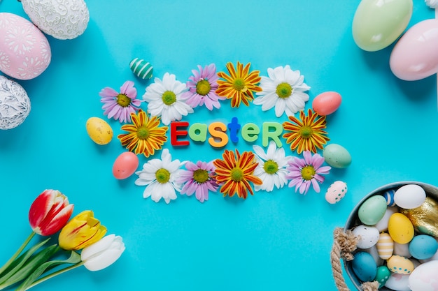 Composed Easter eggs and flowers on blue