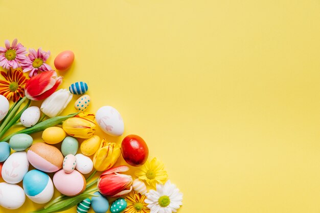 Composed eggs and flowers on yellow