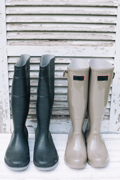 Composed gumboots on white shabby wood
