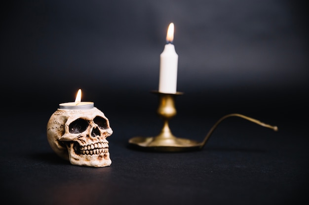 Free photo composed skull and candlestick