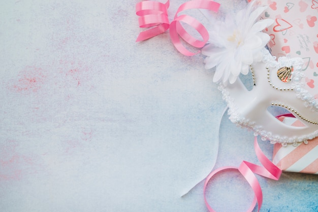 Composed white mask with pink ribbons