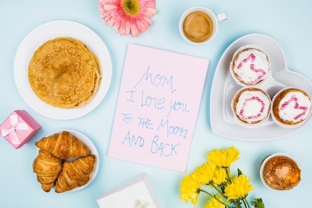 Composition of bakery, flowers and paper with words