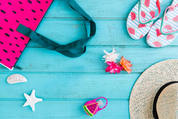 Composition of beach accessories on blue background