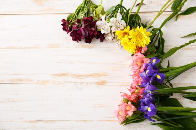 Composition of beautiful flowers on wood