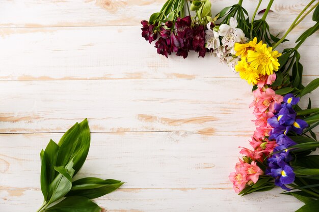 Composition of beautiful flowers on wood