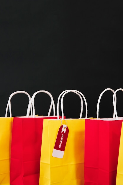 Free photo composition for black friday with yellow and red shopping bags