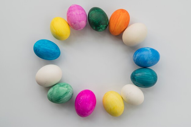 Composition of bright Easter eggs placed in round