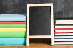 Free photo composition of chalkboard and multicolored books