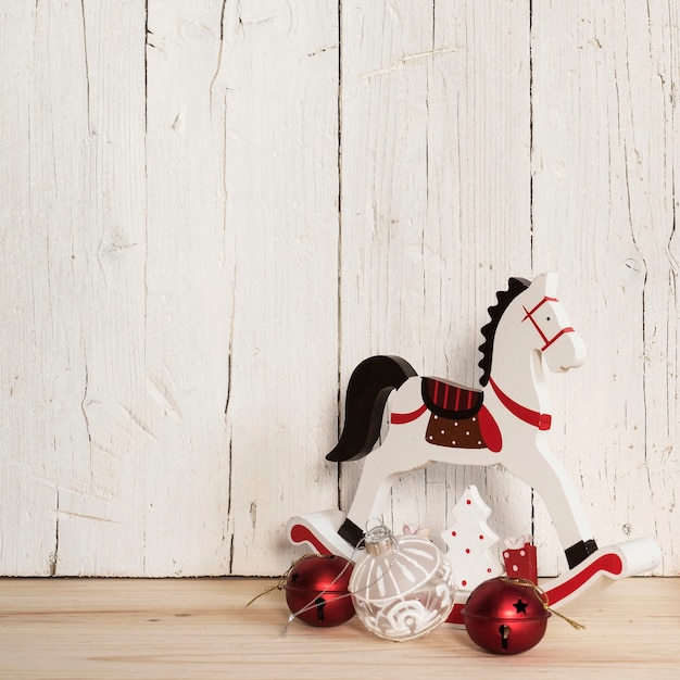 Free photo composition of christmas ornaments and wooden horse with copy space