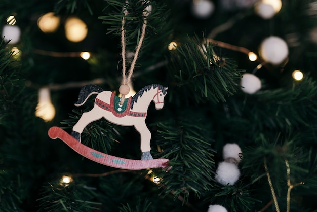Free photo composition of christmas tree with wooden horse ornament