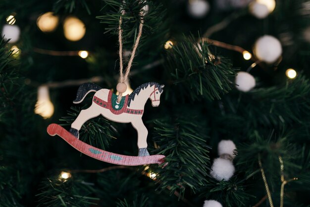 Composition of christmas tree with wooden horse ornament