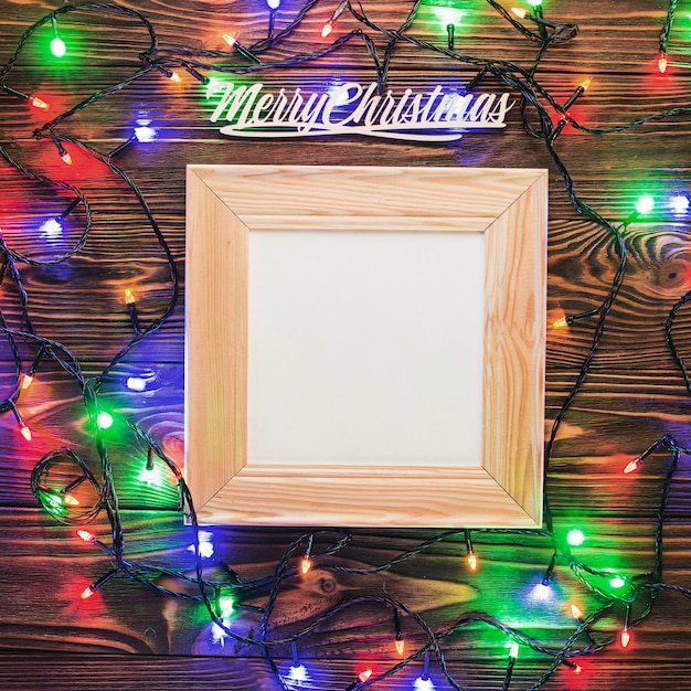 Free photo composition for christmas with wooden frame and lights