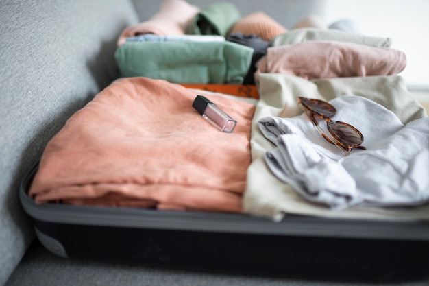 Composition of clothes and accessories in a suitcase