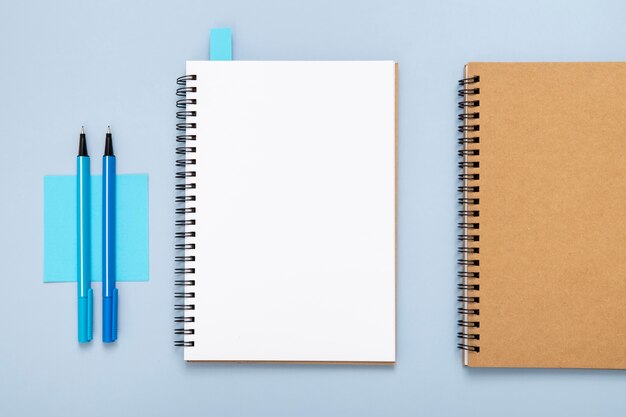 Composition of desk elements with empty notebook