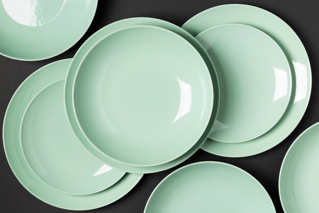 Composition of different sized plates on black background