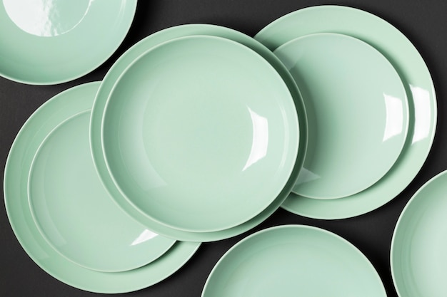 Composition of different sized plates on black background