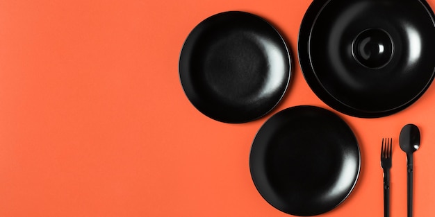 Free photo composition of different sized plates on orange background with copy space