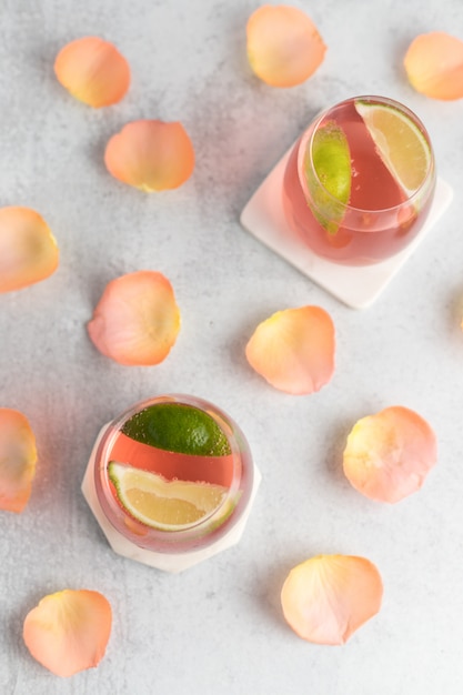 Free photo composition of drinks with lime and petals