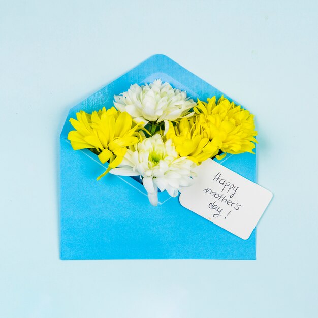 Composition of fresh flowers with tag in envelope