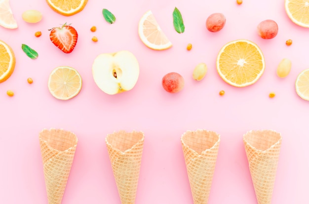 Foto gratuita composizione di frutta assortimento e coni gelato