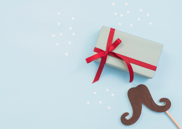 Composition of gift box and mustache stick