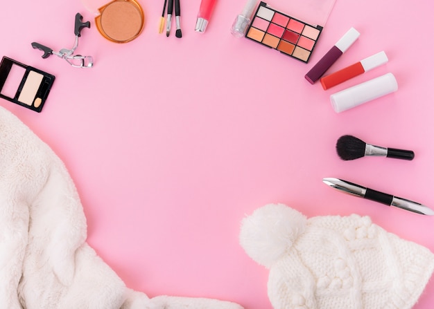 Composition of hat with cosmetics on table