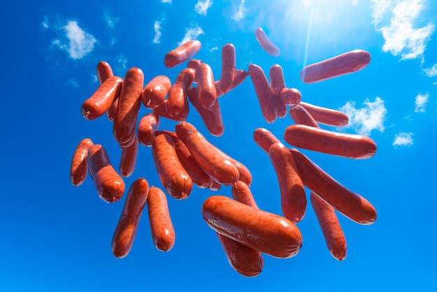 Free photo composition image of german sausage rain on a blue sky background