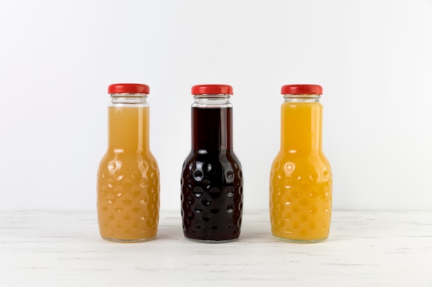 Composition of juice bottles on table