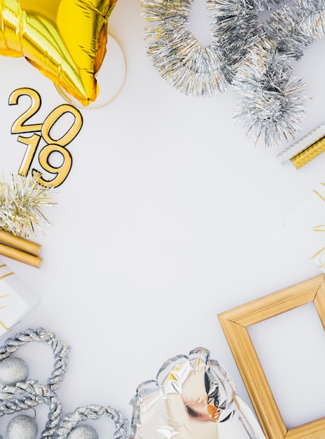 Free photo composition of photo frame, tinsel, 2019 numbers and balloon