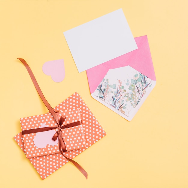 Composition of present boxes, ornament heart, paper and envelope