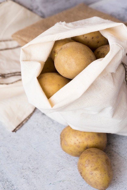 Composition of raw potatoes on cement background