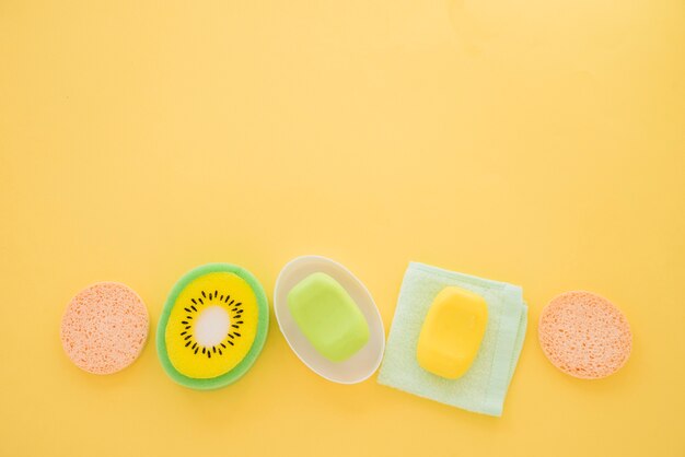 Composition of skin care products on yellow background