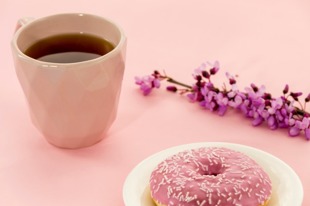 Free photo composition of tea with donuts