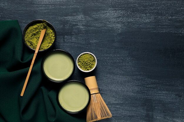 Composition of two mugs with asian tea