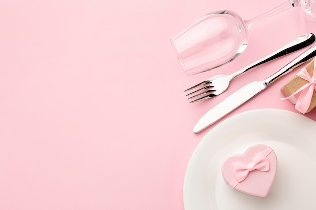 Composition for valentine's day dinner on pink background with copy space