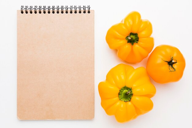 Composition of vegetables on empty notepad