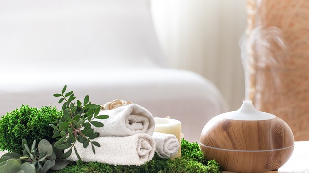 Composition with air humidifier and bath accessories on a blurred background.