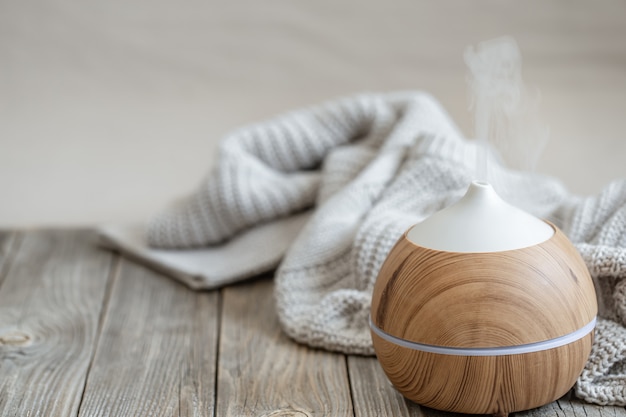 Composition with air humidifier and knitted items close up. Healthy life style concept.