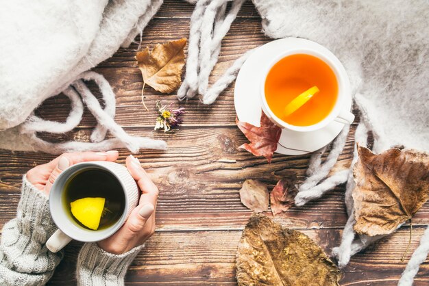 Composition with autumn tea and coffee on table