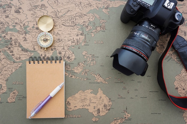 Composition with camera, notebook and compass
