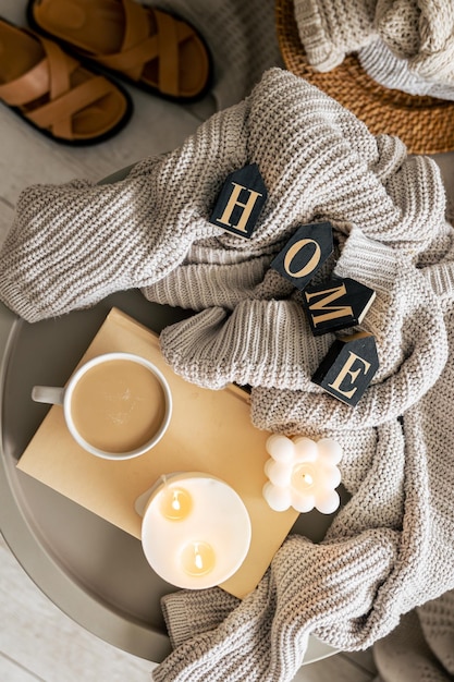 Free photo composition with candles knitted sweater and a cup of coffee top view