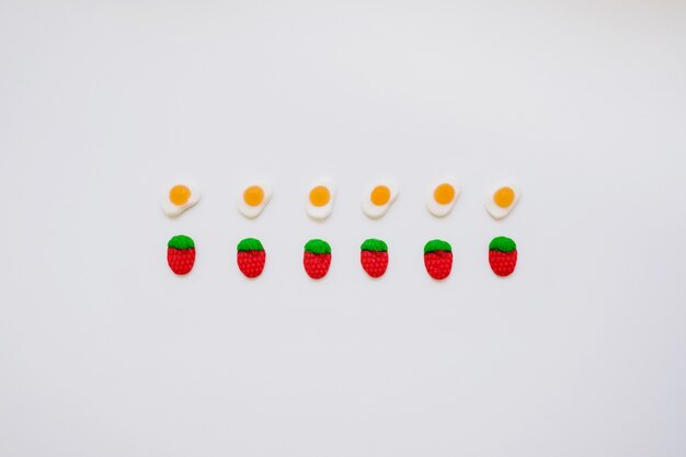 Composition with candy eggs and strawberries