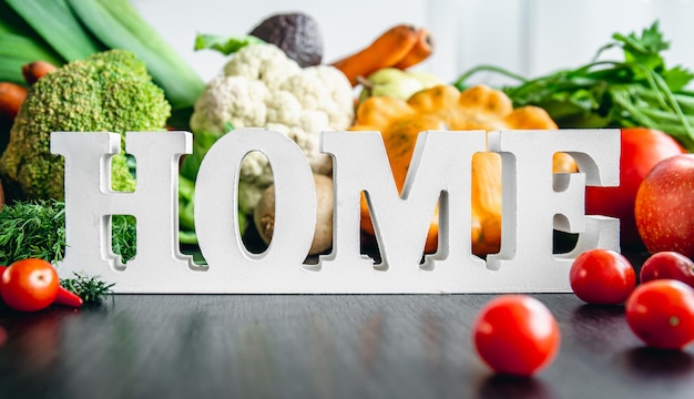 Free photo composition with decorative word home and different vegetables