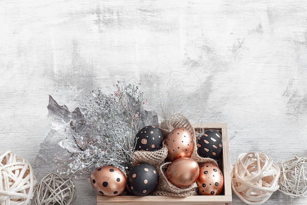 Composition with Easter eggs painted in gold and black colors with ornaments