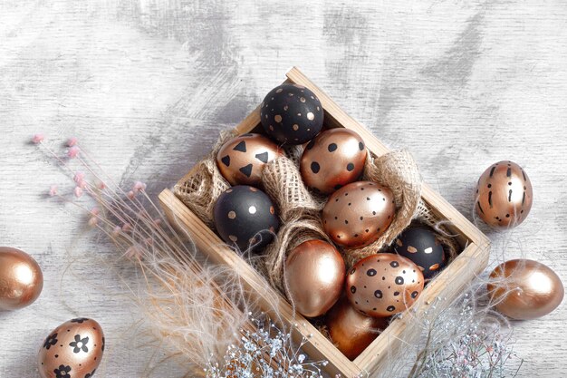 Composition with Easter eggs painted in gold and black.