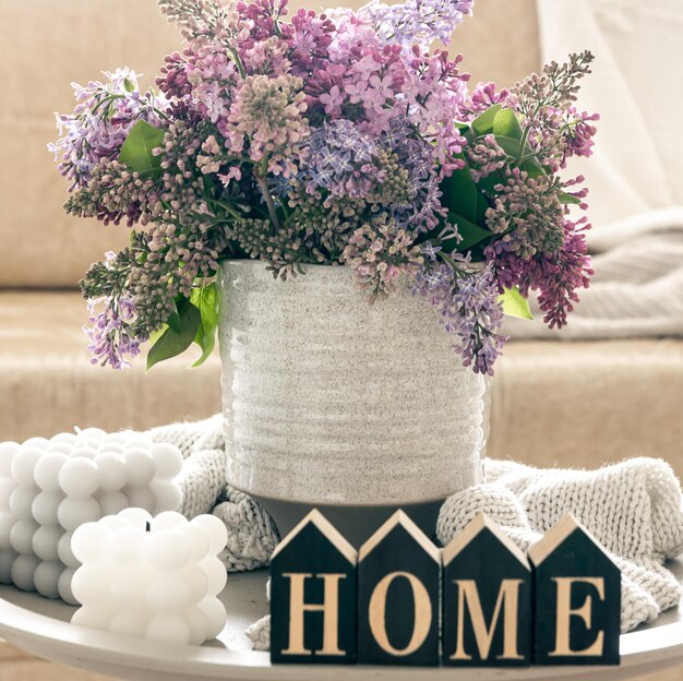 Free photo composition with lilac flowers candles and decorative word home