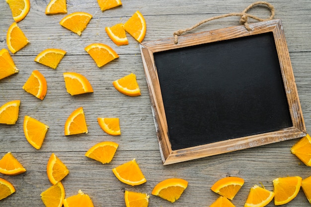 Free photo composition with orange pieces and blank slate