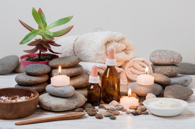 Composition with spa stones and lit candles