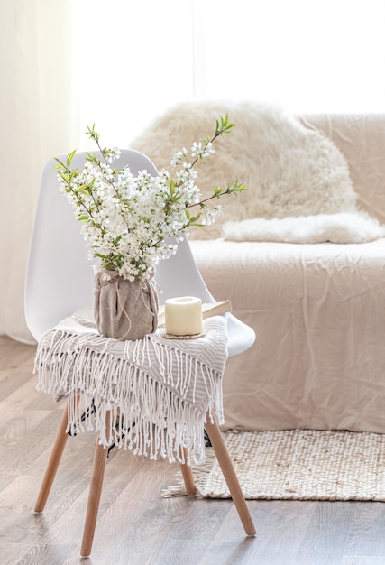 Composition with spring flowers in a cozy living room interior . The concept of decor and comfort.