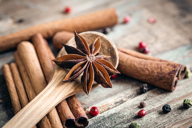 Free Photo composition with star anise and cinnamon sticks on a wooden background